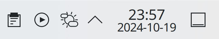 A screenshot of Plasma's tray
showing a clipboard icon, a media control icon, and a weather icon. The weather
icon is displaying a sun with few clouds in front. The tray is also showing the
time. It is 23:57.